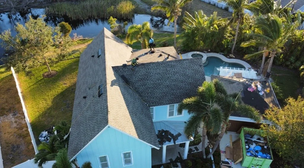 Charcoal gray architectural shingles installed on multi-pitched residential roof with complex angles and transitions