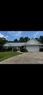 New gray asphalt shingle roof on single-story residential home with white trim