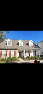 Two-story colonial home with multi-plane asphalt shingle roof and dormers