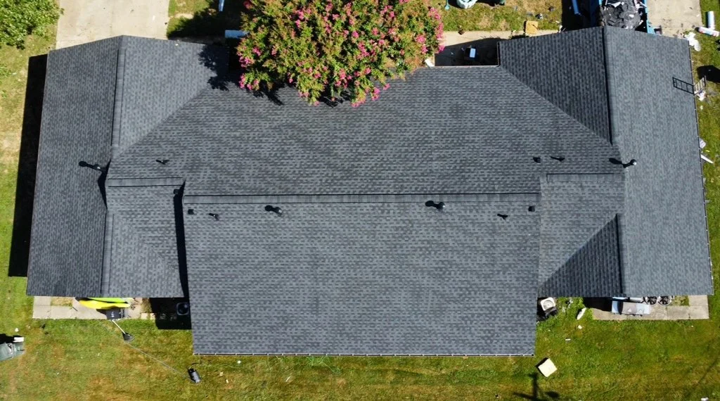 Aerial view of charcoal gray architectural shingle roof with ridge vents and proper installation
