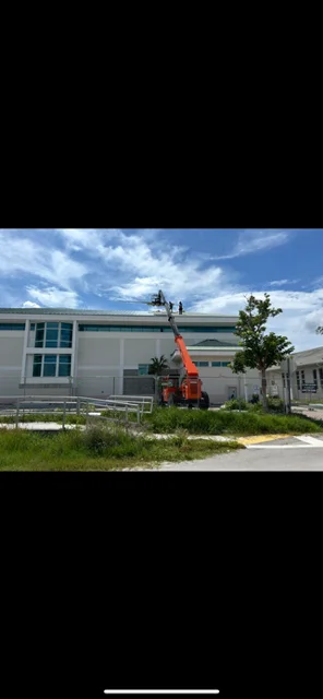 Commercial building with flat roof installation using elevated work platform and metal trim